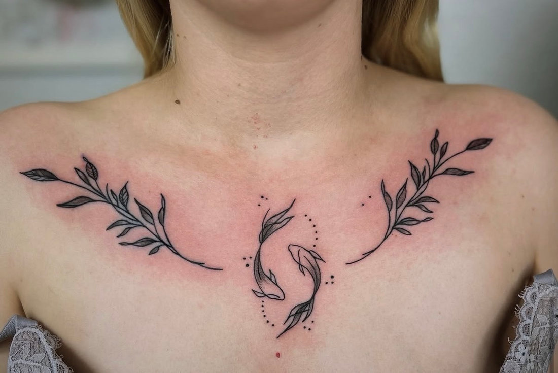 Koi fish and laurel branches tattoo across the collarbone